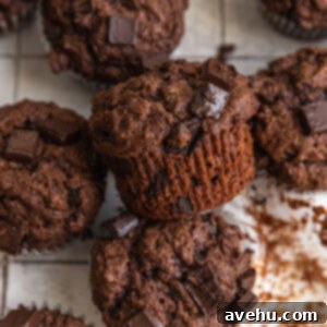 Ultimate Bakery Triple Chocolate Muffins 11 Triple chocolate muffins on a tiled backdrop.