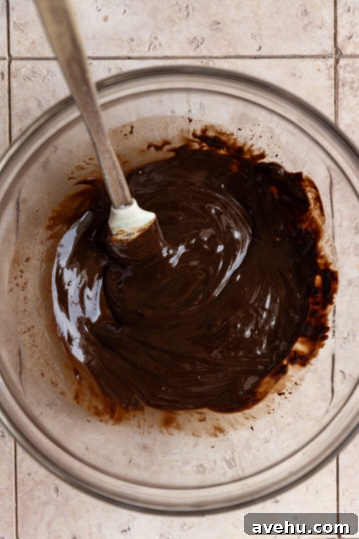 Ultimate Bakery Triple Chocolate Muffins 4 Melted butter and chocolate in a glass bowl.