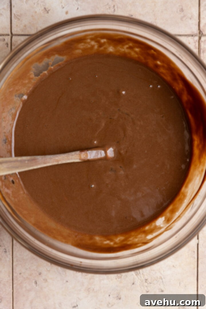 Ultimate Bakery Triple Chocolate Muffins 5 Wet ingredients for chocolate muffins in a bowl.