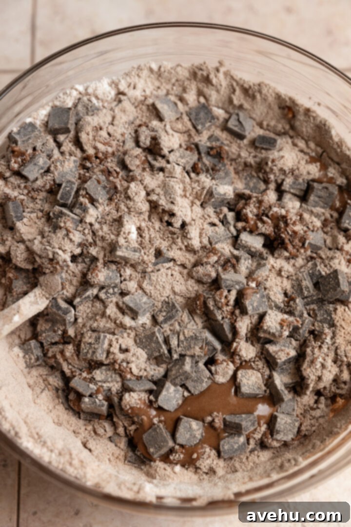 Ultimate Bakery Triple Chocolate Muffins 6 Ingredients for triple chocolate muffins mixed together in a bowl.