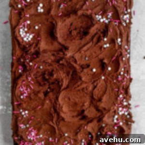 One Bowl Fluffy Chocolate Dream Cake 2 A one bowl chocolate cake with chocolate buttercream and sprinkles sheet cake on a gray background.