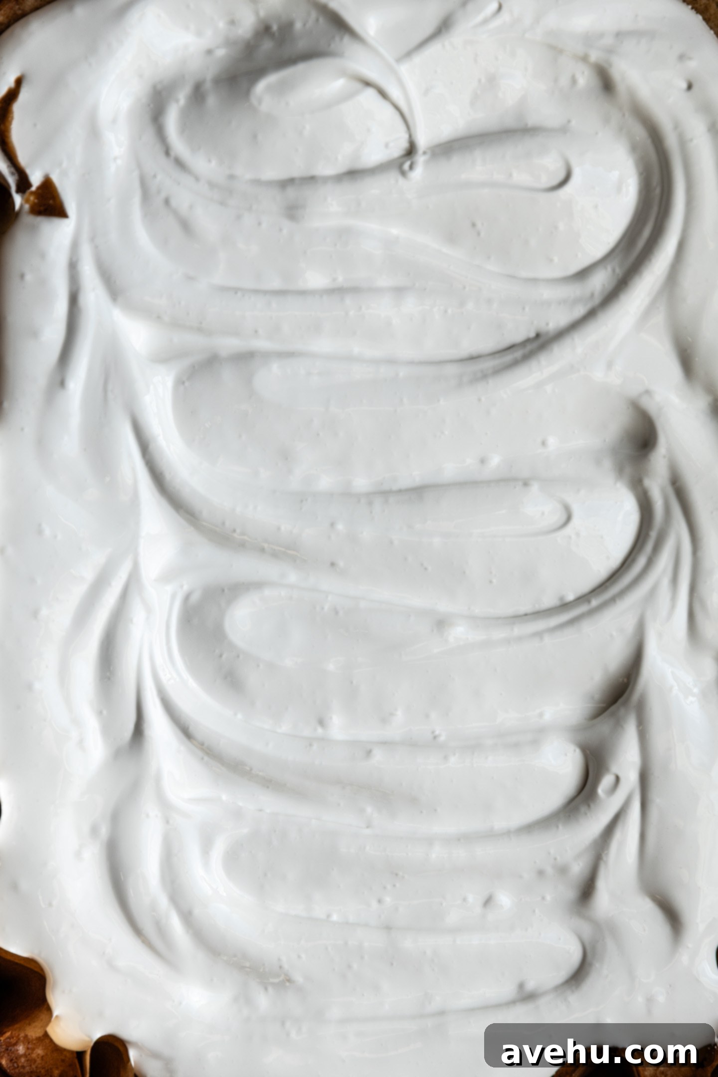 Effortless 7-Minute Frosting 3 Thick 7 minute frosting slathered over a cake, ready to be torched.