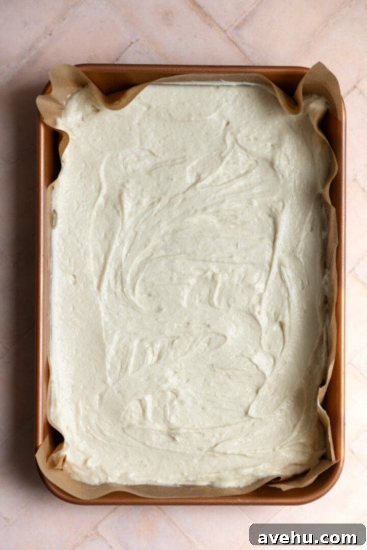 The Ultimate Vanilla Sheet Cake 8 Vanilla sheet cake batter in a 9x13 lined pan.