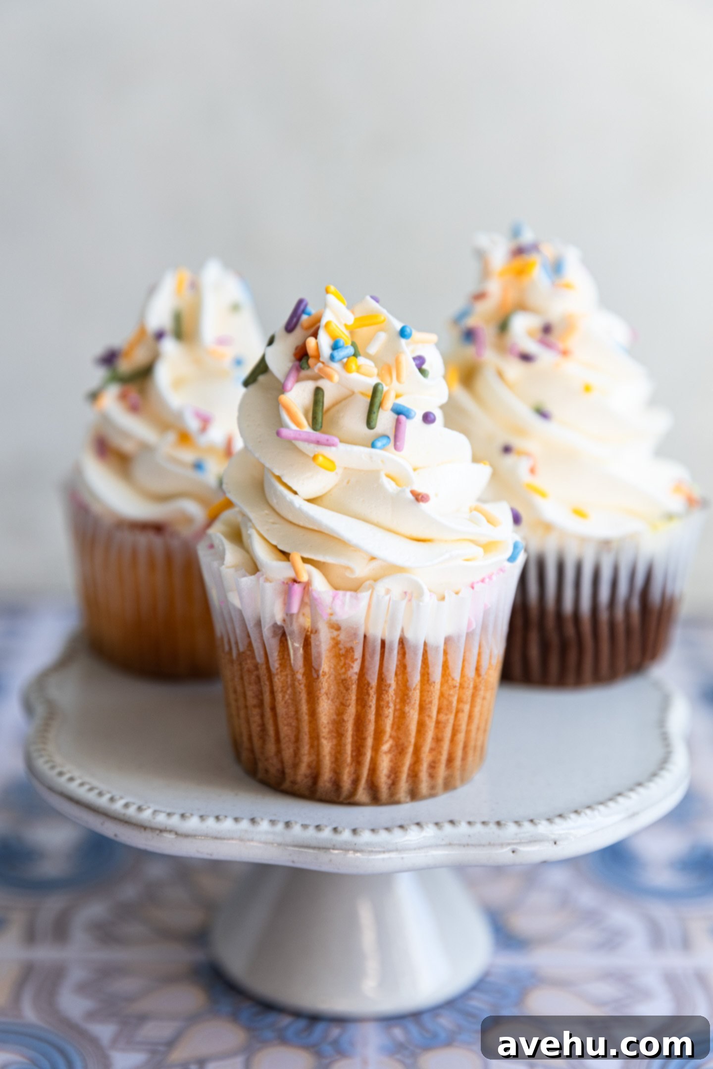 Seriously Addictive Swiss Meringue Buttercream 17 3 cups frosted with Swiss Meringue Frosting on a mini cake stand.
