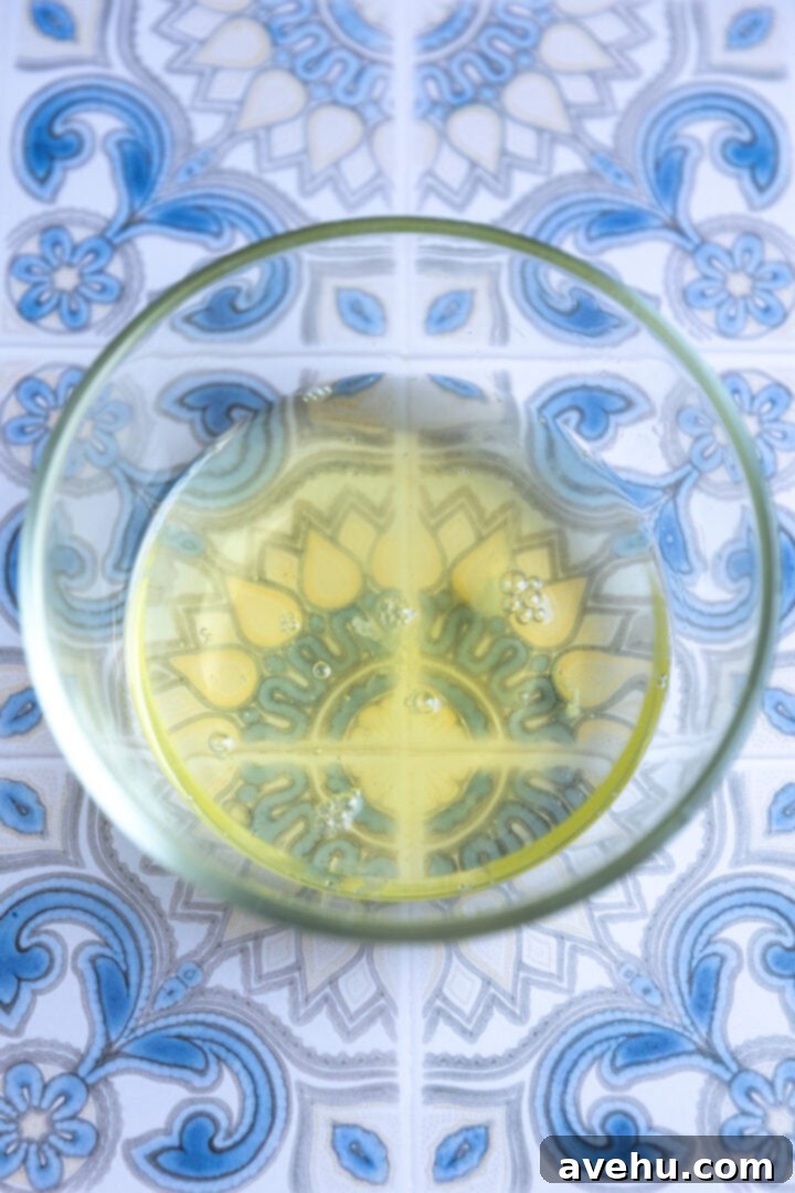 Seriously Addictive Swiss Meringue Buttercream 7 Egg whites in a glass bowl.