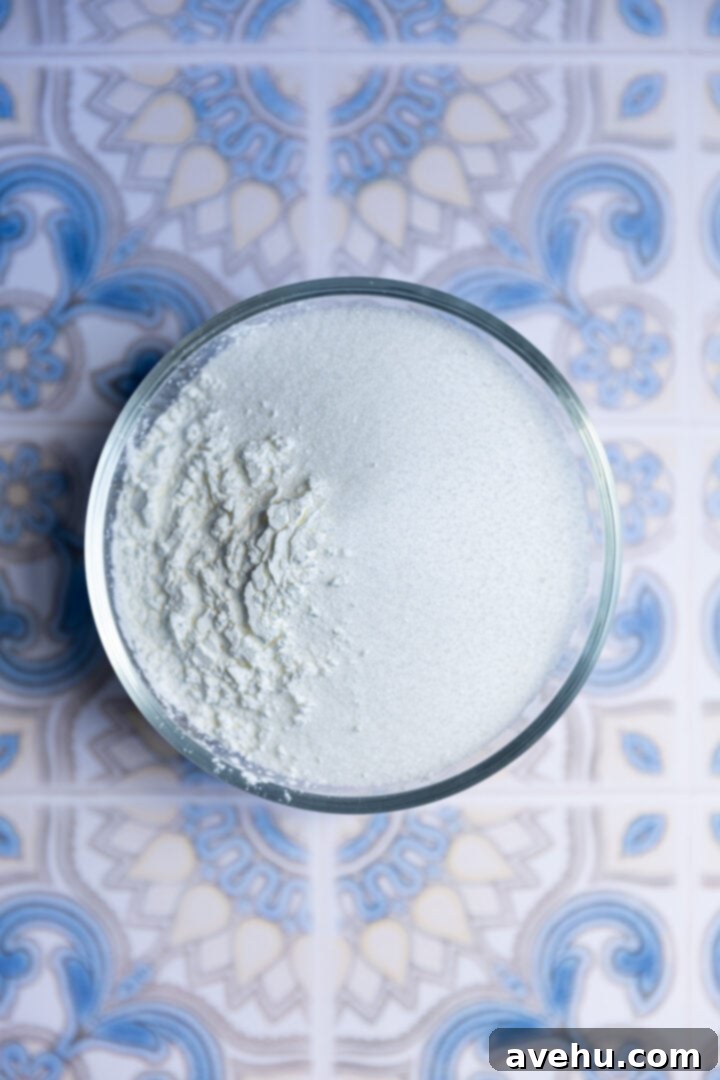 Seriously Addictive Swiss Meringue Buttercream 8 Sugar and corn starch in a glass bowl.