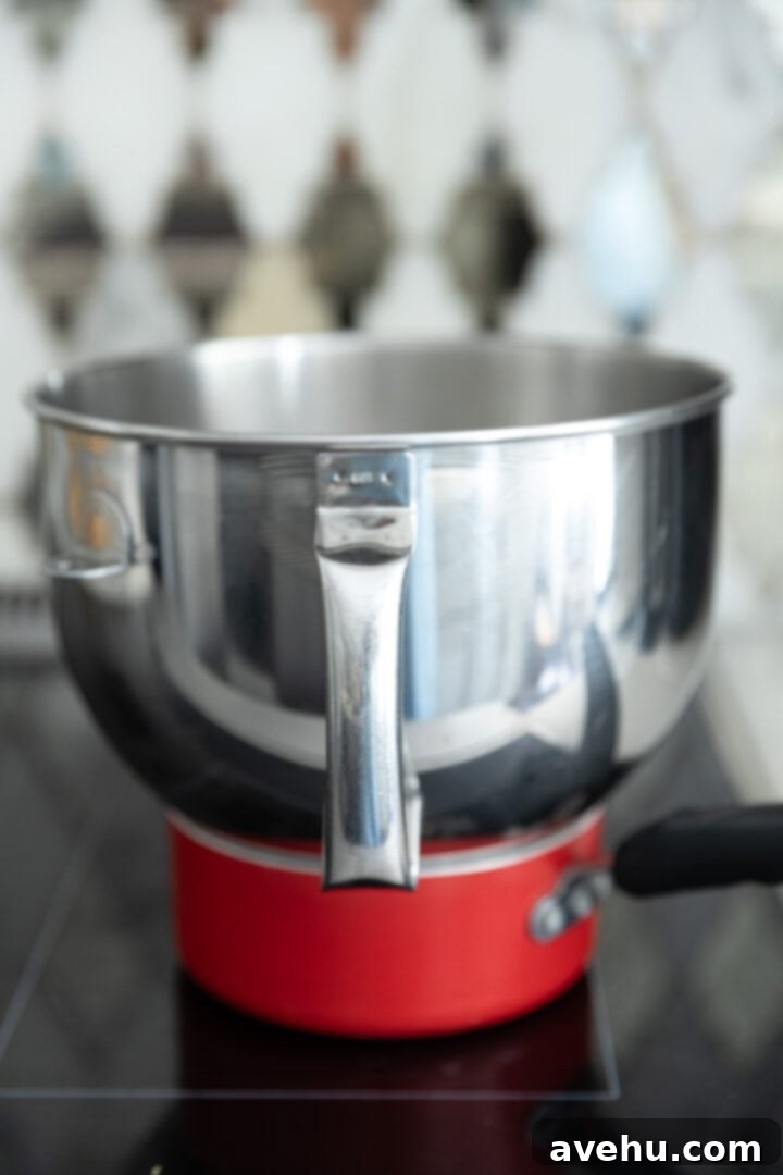 Seriously Addictive Swiss Meringue Buttercream 9 A double boiler on a stove top.