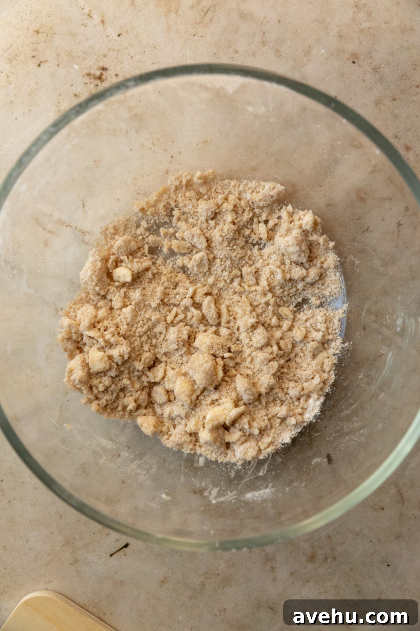 Perfectly Moist Bakery-Style Banana Muffins 3 Unbaked streusel mixture in a glass bowl, ready for chilling.