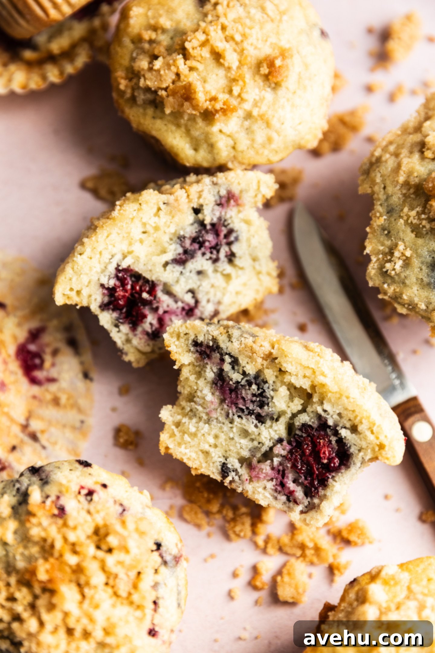 Crave-Worthy Blackberry Streusel Muffins 2 A perfectly baked blackberry streusel muffin, cut in half to reveal juicy blackberries within.