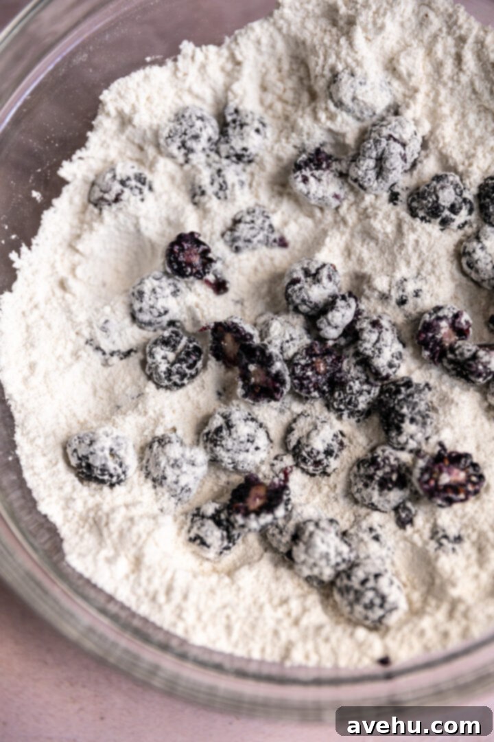 Crave-Worthy Blackberry Streusel Muffins 6 Halved fresh blackberries coated in dry ingredients in a glass bowl.
