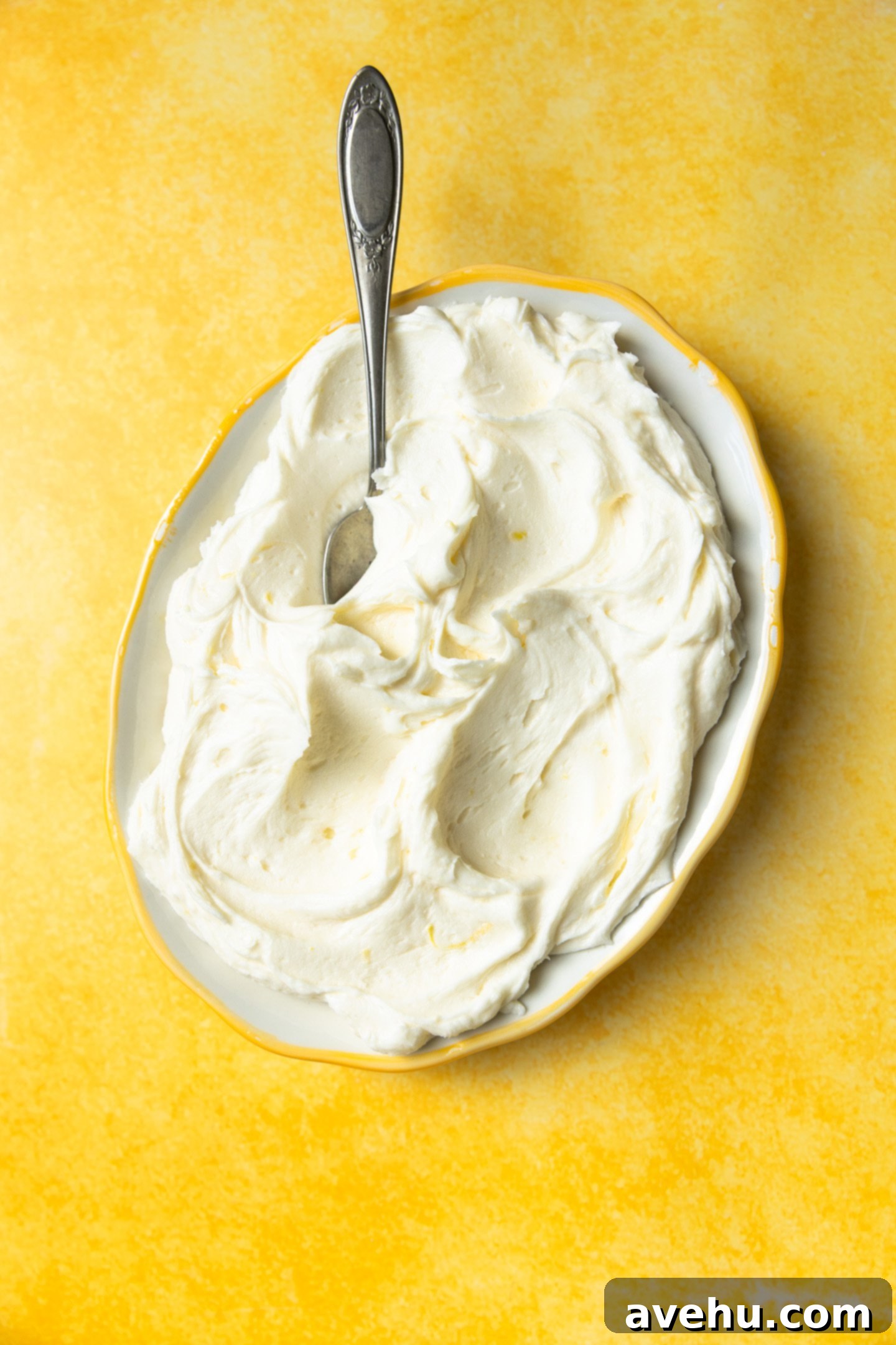 Zesty Lemon Curd Delight 2 Lemon curd frosting on a platter with a spoon