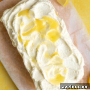 Zesty Lemon Curd Delight 11 A loaf cake topped with lemon curd frosting.