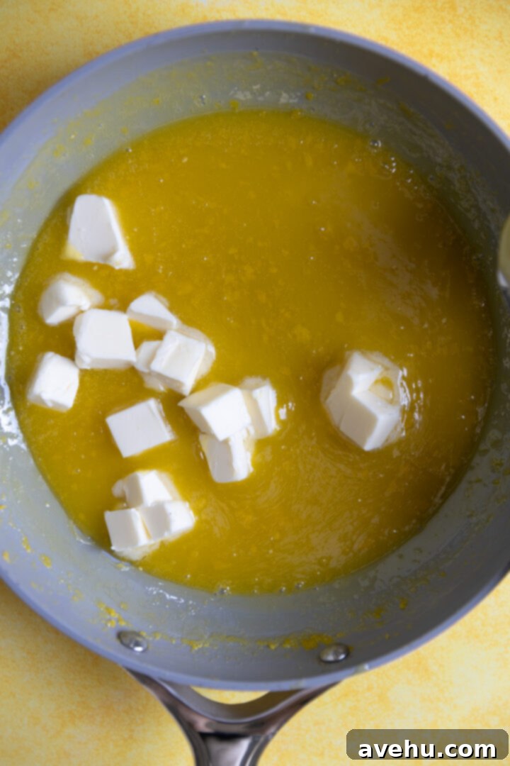 Zesty Lemon Curd Delight 5 Diced butter added to lemon curd.