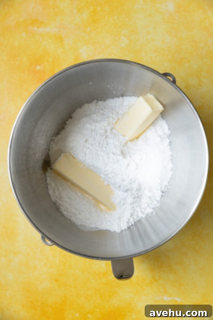 Zesty Lemon Curd Delight 7 Powdered sugar and butter in a mixing bowl.