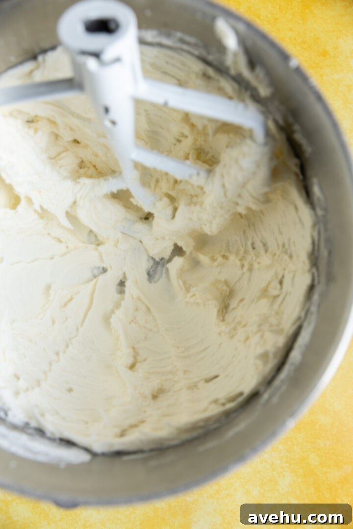 Zesty Lemon Curd Delight 8 Whipped butter and powdered sugar in a mixing bowl.