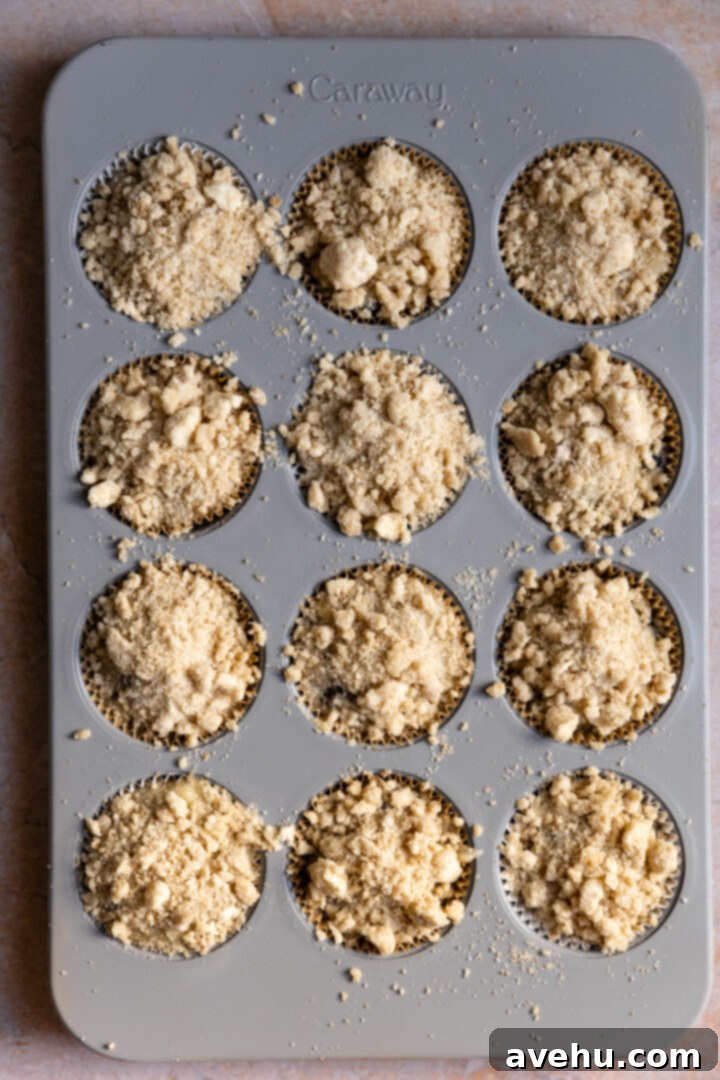 Ultimate Bakery Banana Blackberry Muffins 11 Muffin tin with batter topped generously with streusel.