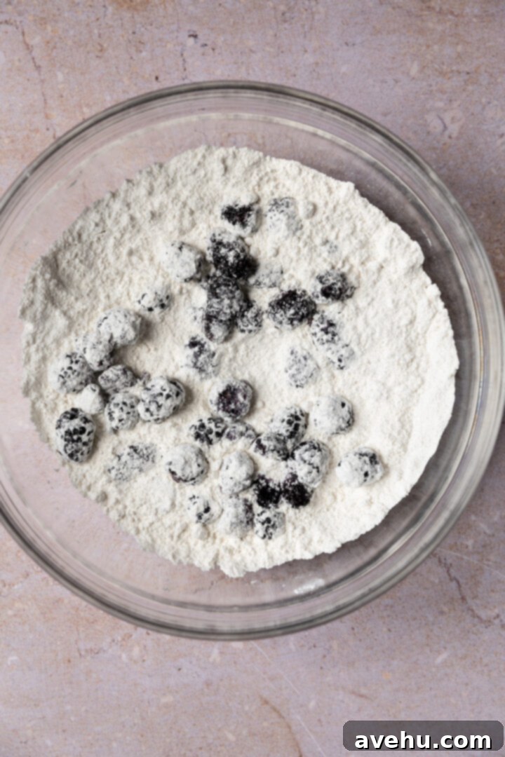 Ultimate Bakery Banana Blackberry Muffins 6 Halved fresh blackberries in a bowl, lightly coated with flour.