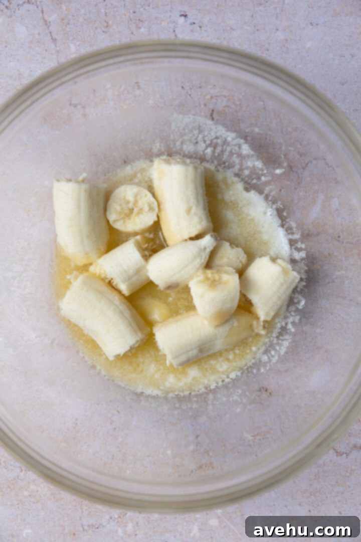 Ultimate Bakery Banana Blackberry Muffins 7 Melted butter and mashed overripe bananas in a bowl.