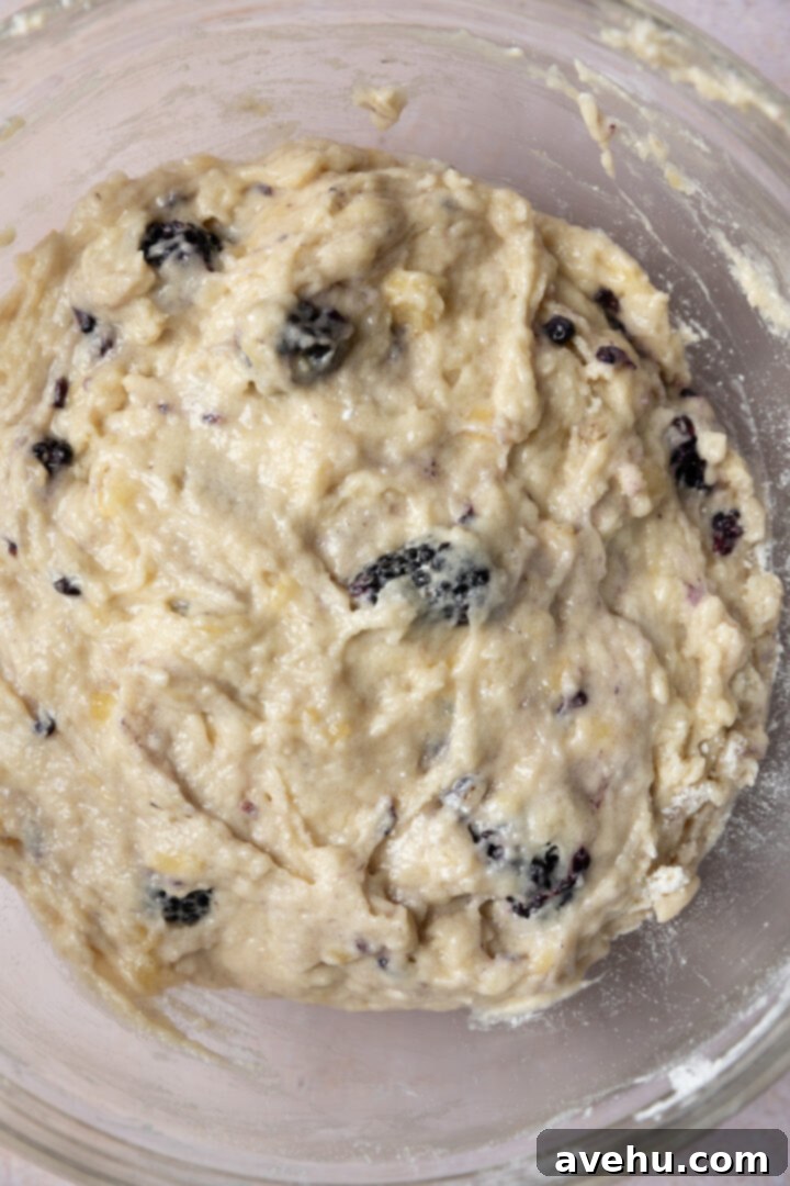 Ultimate Bakery Banana Blackberry Muffins 9 Thick, lumpy batter for banana blackberry muffins in a bowl.