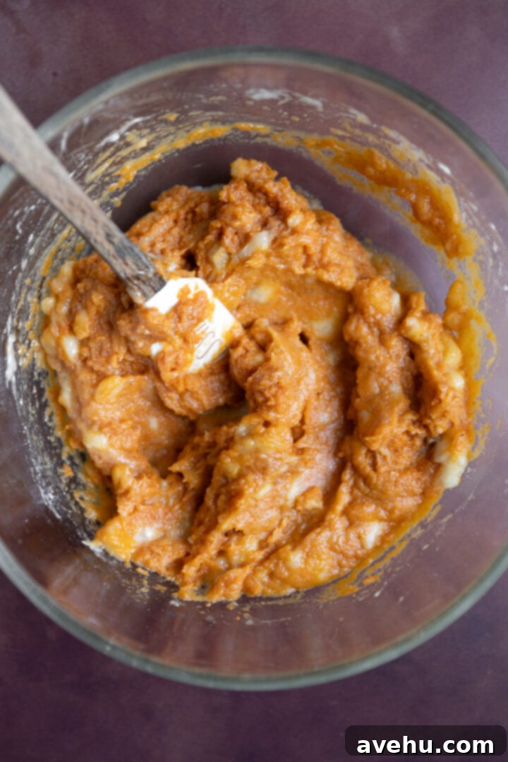 Bakery-Fresh Moist Pumpkin Banana Muffins 5 Smooth mixture of pumpkin puree and mashed banana in a glass bowl, ready for additional liquid ingredients.