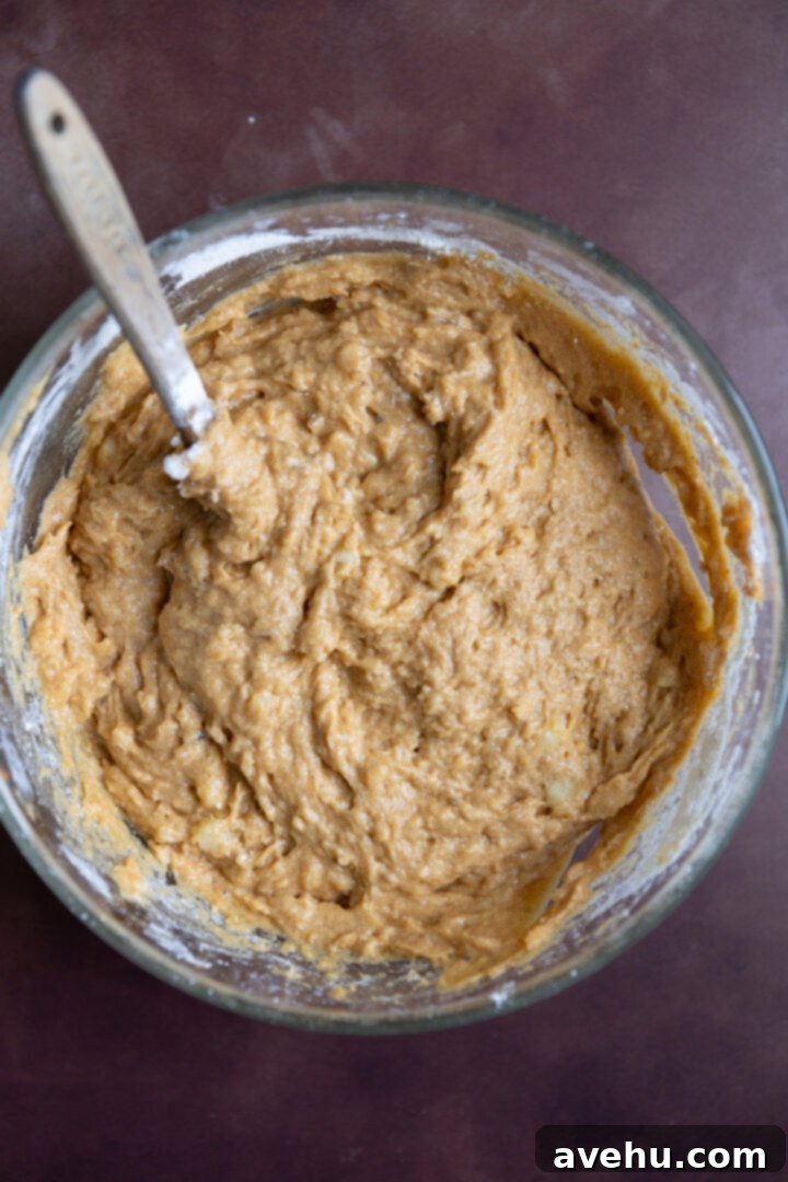Bakery-Fresh Moist Pumpkin Banana Muffins 8 Thick, lumpy muffin batter, perfectly mixed with no visible streaks of flour, ready for scooping into a muffin tin.