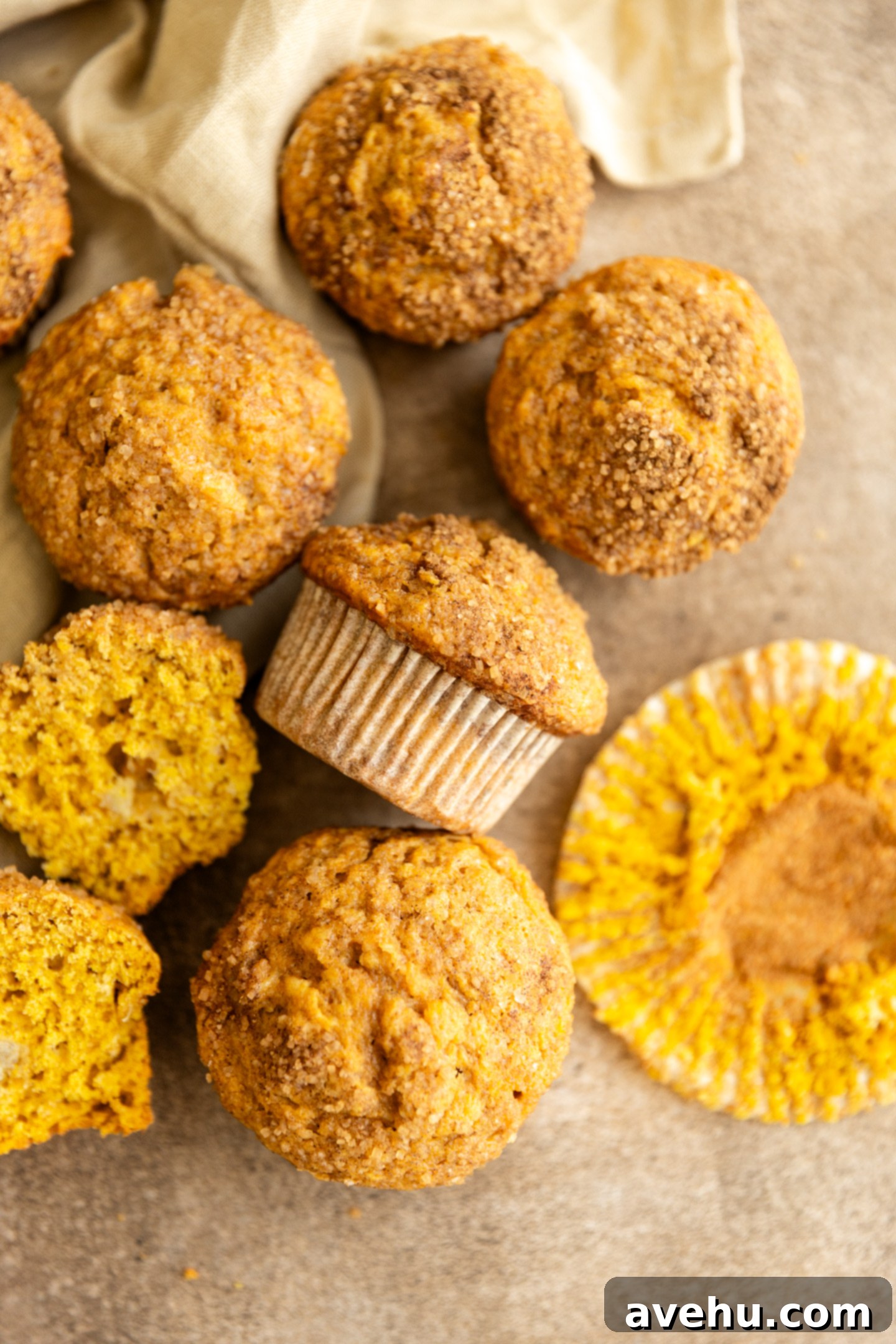 Bakery-Fresh Moist Pumpkin Banana Muffins 10 Freshly baked banana pumpkin muffins cooling on a wire rack, with their golden brown tops and cinnamon sugar sparkle visible, ready to be enjoyed.