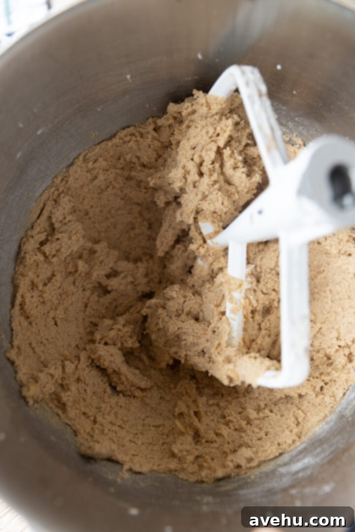 Maple-Glazed Autumn Apple Bites 6 Batter for apple cookies in a mixing bowl.