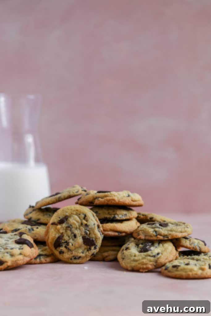 Decadent Salted Caramel Chocolate Chip Cookies 4 Salted caramel chocolate chip cookies displayed on a pink background.