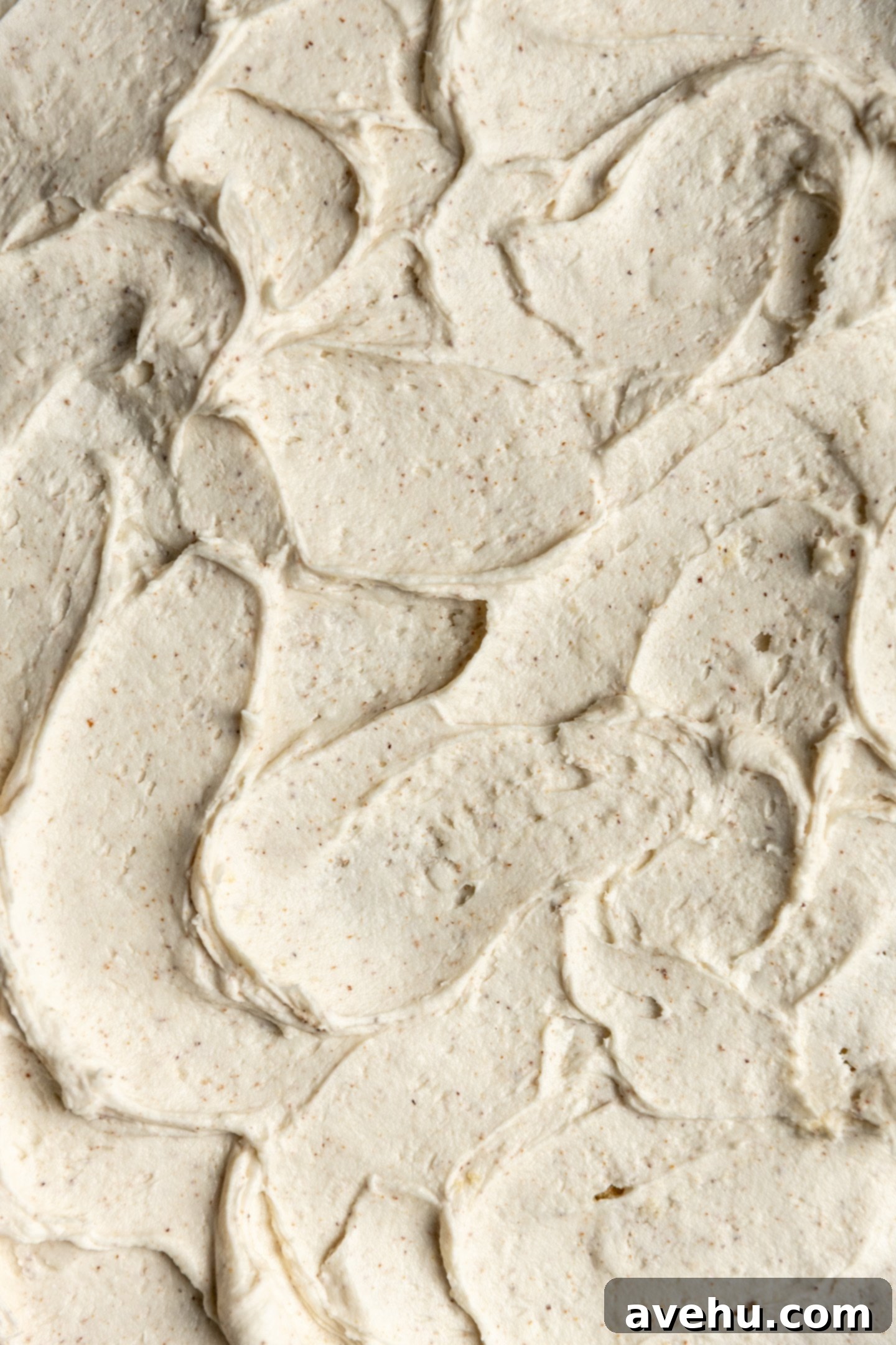 Your Ultimate Brown Butter Frosting 2 Swirls of fluffy brown butter frosting on a delicious cake, showcasing its rich, amber color and smooth texture.