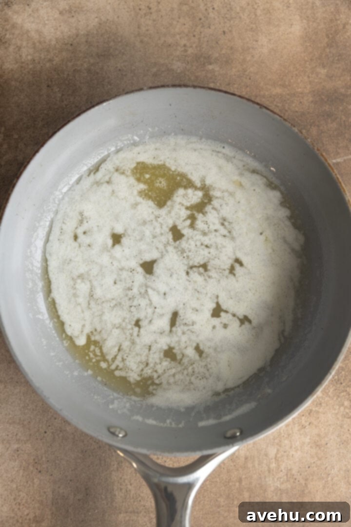 Your Ultimate Brown Butter Frosting 4 Melted butter foaming gently in a saucepan, signaling the start of the browning process.