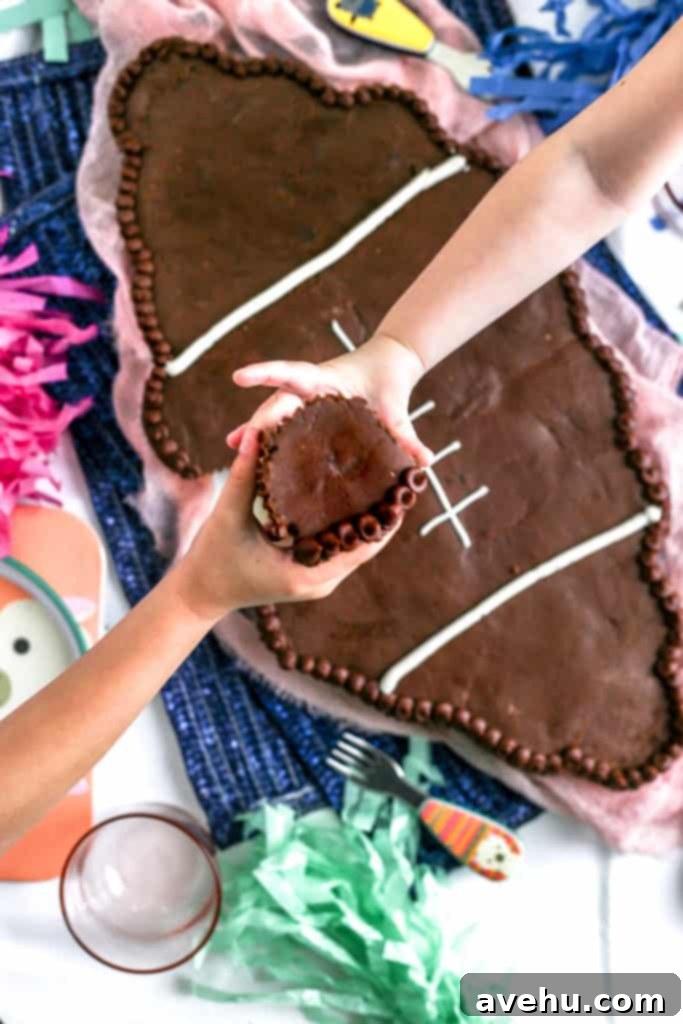 Game Day Pull Apart Football Cupcakes 7 Children happily passing chocolate cupcakes from the football cake, demonstrating the ease of serving.