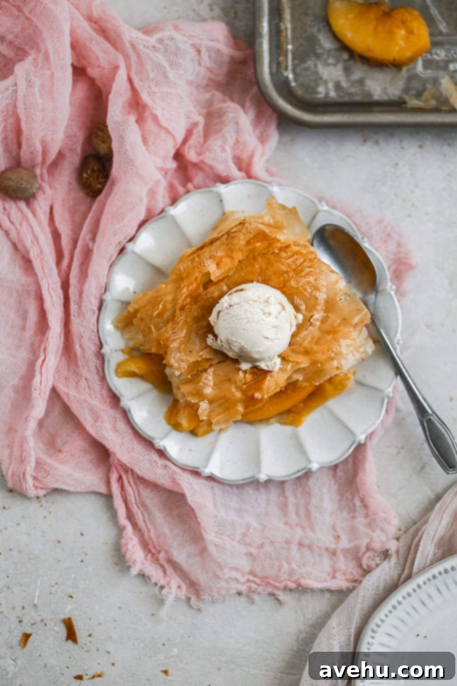 2018 Saveur Blog Awards Peach Slab Pie 3 A flakey peach slab pie topped with ice cream.