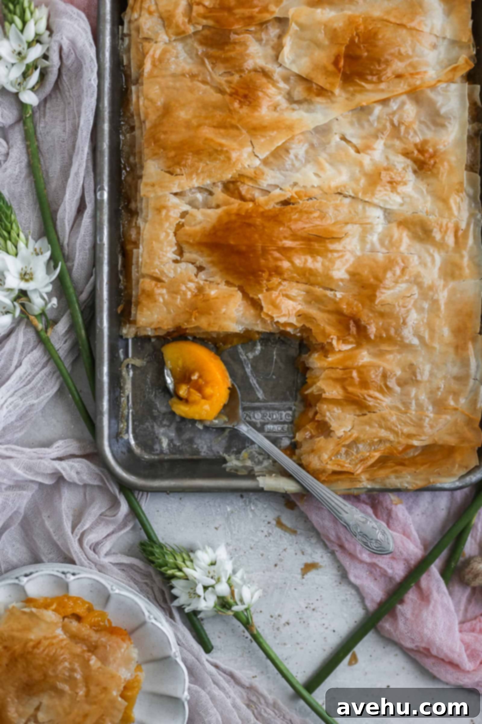 2018 Saveur Blog Awards Peach Slab Pie 6 A spoonful of peach slab pie in a sheet tray
