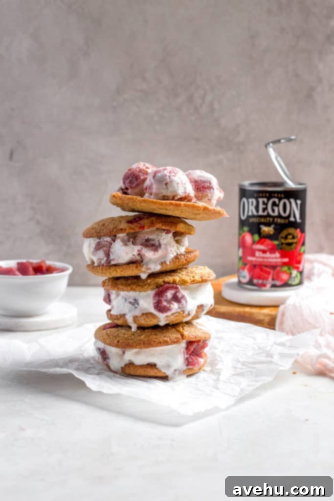 Tangy-Sweet Rhubarb Strawberry Ice Cream Sandwiches 3 Close-up of perfectly stacked rhubarb ice cream sandwiches, showing the soft cookie texture and the creamy pink ice cream filling.