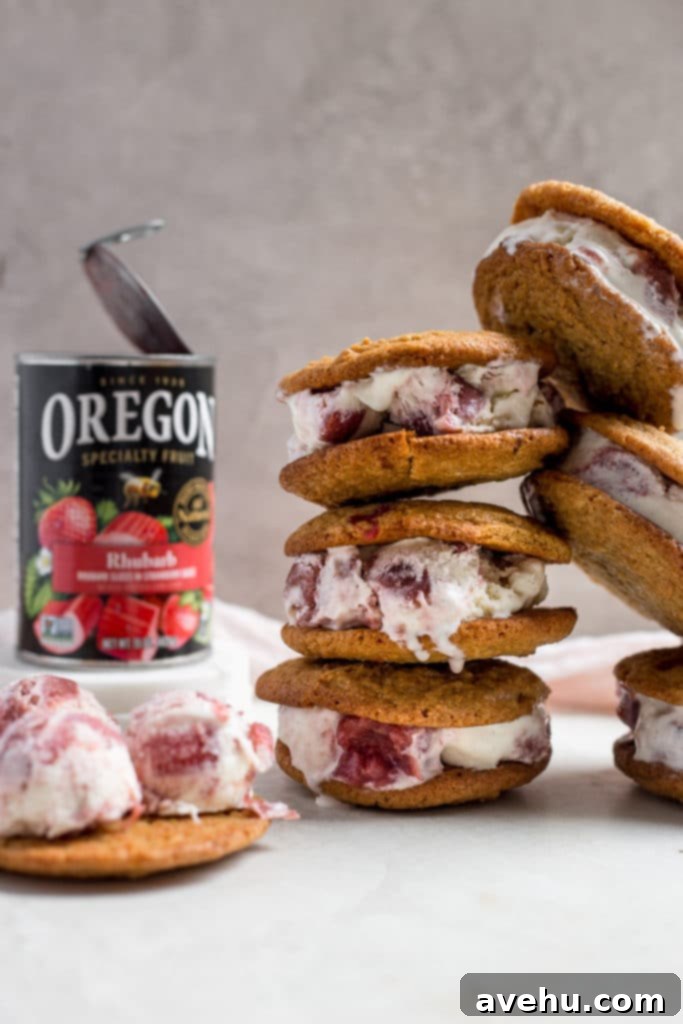 Tangy-Sweet Rhubarb Strawberry Ice Cream Sandwiches 6 Assembled rhubarb ice cream sandwiches, stacked casually, showing the thick, creamy ice cream and chewy cookies.