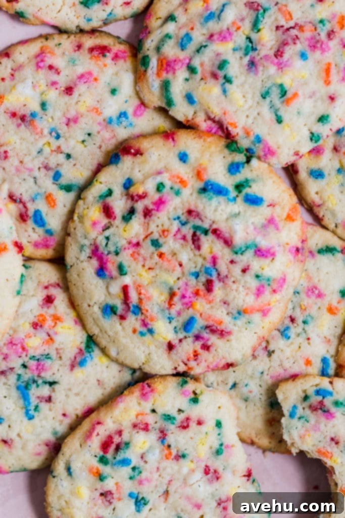 Scratch Baked Funfetti Delights 7 A stack of golden-edged, sprinkle-filled funfetti cookies, showcasing their chewy texture