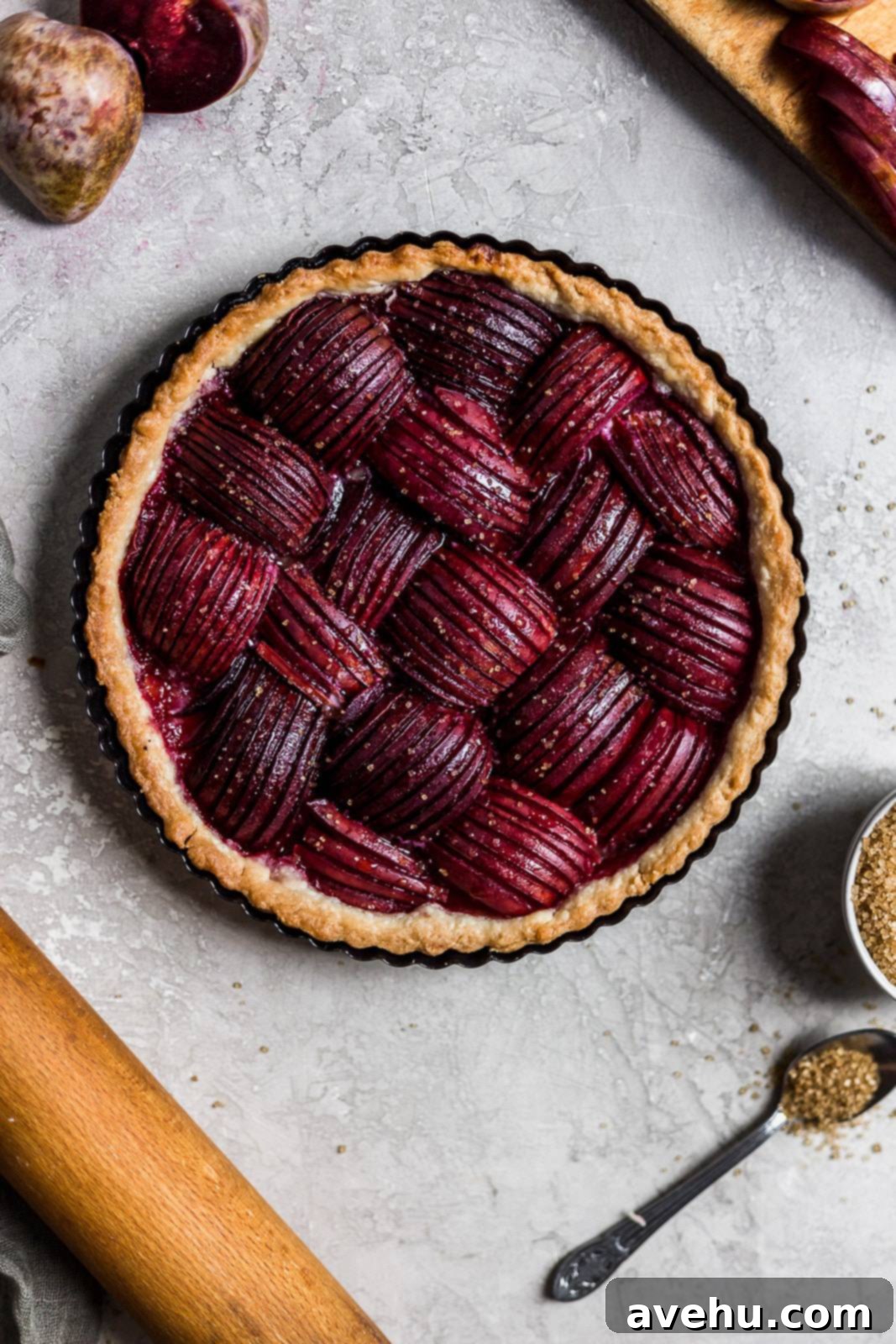 Effortlessly Elegant Plum Tart 4 A freshly baked plum tart, glistening with honey and butter, showcasing beautifully arranged plums.