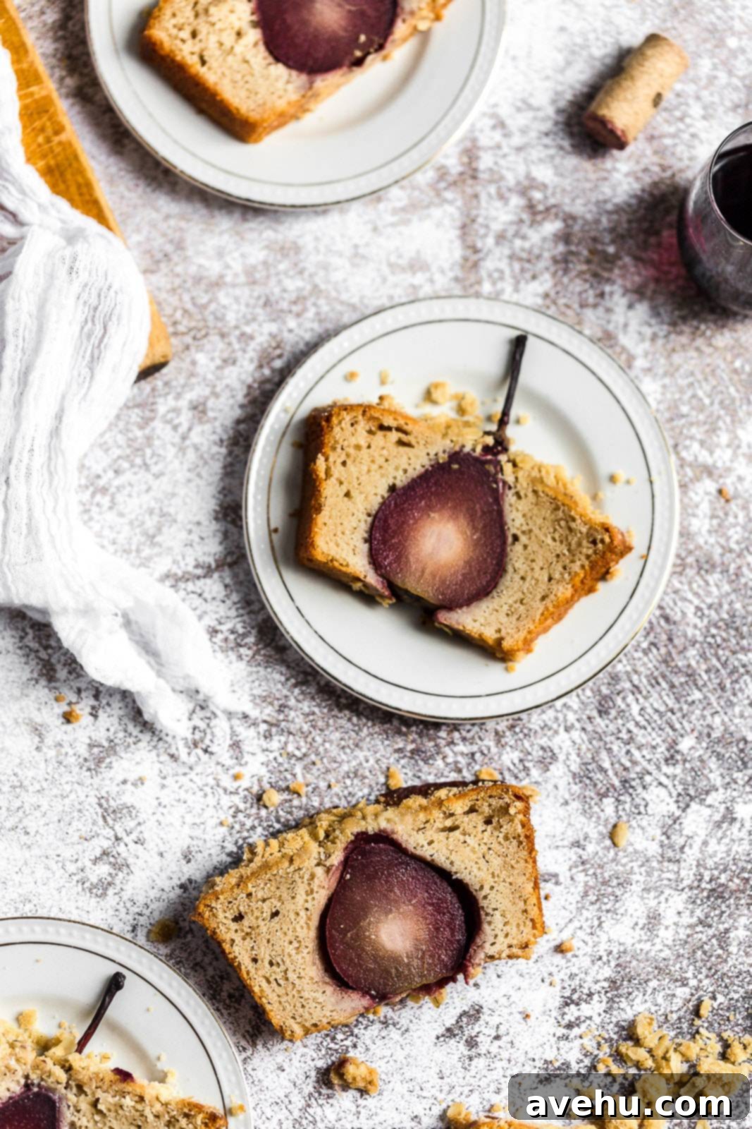 Sweet Pear Streusel Delight 7 A single slice of the red wine poached pear cake on a white plate, ready to be enjoyed.