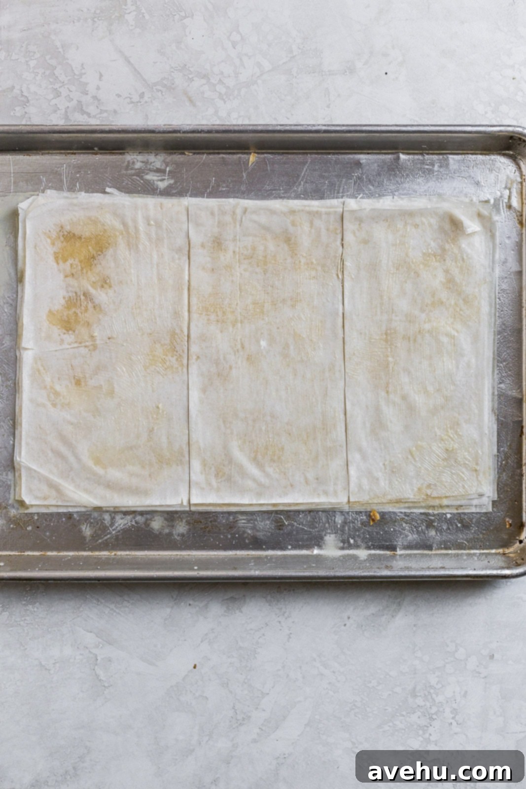 Decadent Caramel Mascarpone Napoleon 4 Phyllo dough layers brushed with butter and cut into thirds on a baking tray.