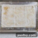 Phyllo dough stacks cut into thirds on a sheet tray