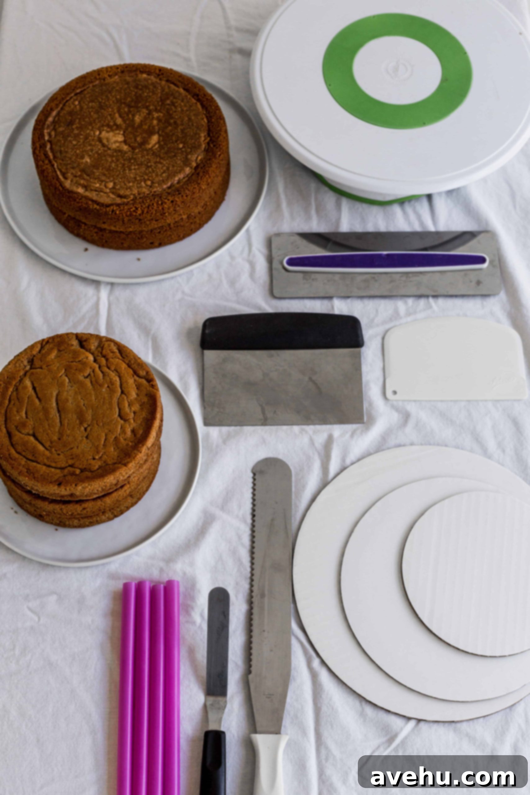 Mastering Two-Tier Cakes: Baking and Stacking Techniques 3 Tools needed when stacking a cake- cakes, cake boards, a knife, bubble stress, bench scrapers, and a turntable.