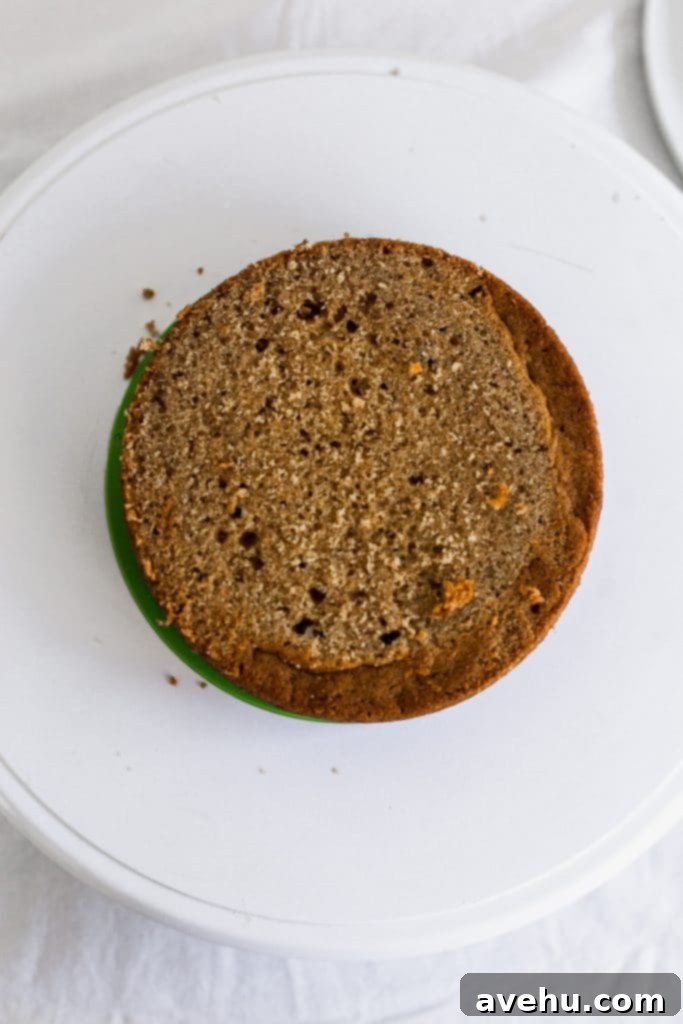 Mastering Two-Tier Cakes: Baking and Stacking Techniques 4 A cake top cut off flat on a white surface