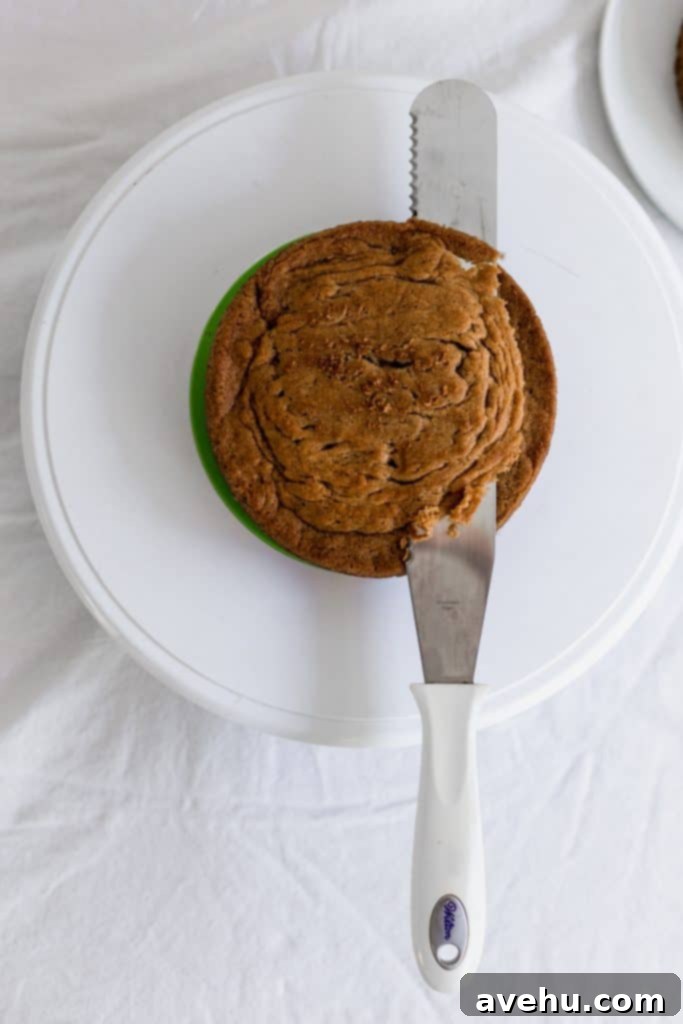 Mastering Two-Tier Cakes: Baking and Stacking Techniques 5 A lone serrated knife cutting off the top of a cake to make it flat