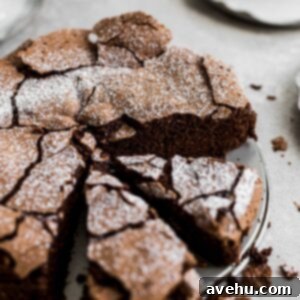 Flourless Chocolate Dream Cloud 2 The top of a flourless chocolate cake with 2 slices cut out.