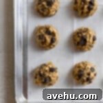 Simply Irresistible Chewy Oatmeal Chocolate Chip Cookies 7 Cookie dough balls lined up next to each other in two straight rows.