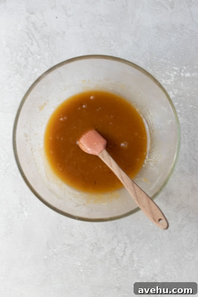 Speedy Six Chocolate Chip Cookies 2 Melted butter and sugar mixed in glass bowl.