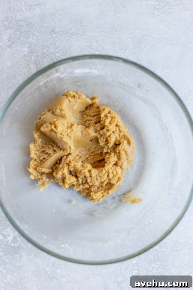 Speedy Six Chocolate Chip Cookies 3 Cookie dough without chocolate chips in a glass bowl.