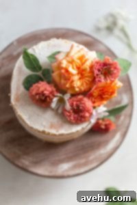 Your Guide to Stunning Floral Naked Cakes 12 Flowers on a white cake on a wood surface