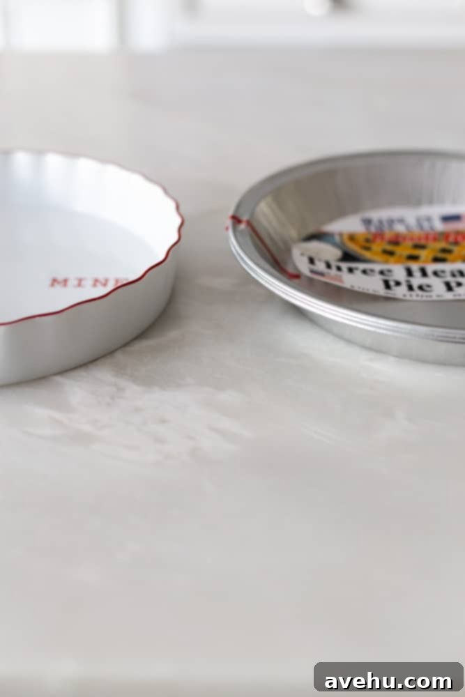 Layers of Perfection: Flaky Pie Crust 14 A ceramic pie plate with straight sides juxtaposed next to an aluminum pie plate with sloped sides, highlighting the visual and functional differences between them.