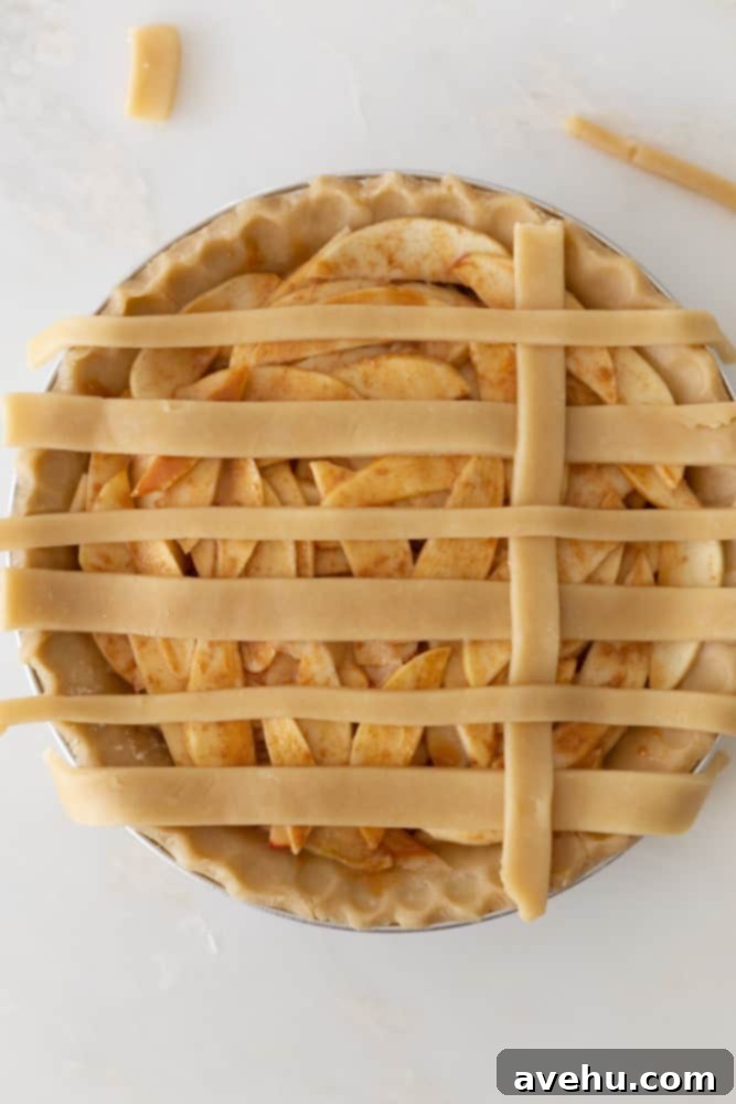 Sweet & Simple Caramel Apple Lattice Pie 12 Folding the previously peeled horizontal strips back over the newly placed vertical strip to secure the weave.